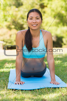 Healthy and beautiful woman exercising in park