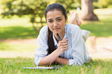 Portrait of a woman with book and pen in park