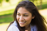 Close-up of a smiling woman looking away in park