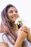 Close-up of a smiling young woman holding flowers
