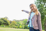 Cute smiling young girl standing at park