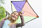 Low angle view of a cute girl with a kite