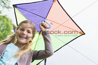 Portrait of a cute girl with a kite