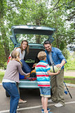 Family unloading car trunk while on picnic