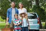 Happy family with car at picnic
