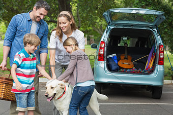 Family with kids and pet dog at picnic
