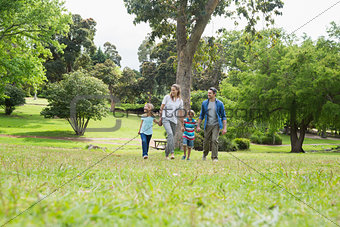 Parents and kids walking in park