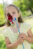 Cute girl holding pinwheel at park