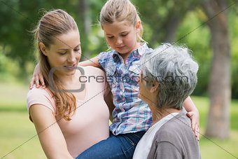 Grandmother mother and daughter at park