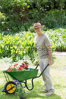 Mappy male gardening with wheelbarrow at garden