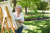 Mature woman painting in park