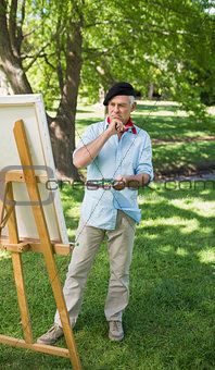 Full length of a mature man painting in park