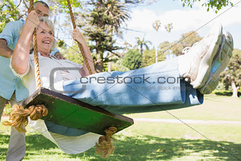 Mature couple at swing in the park