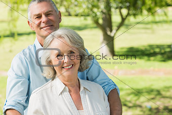 Smiling mature couple at summer park