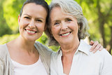 Close-up of smiling mature woman with daughter at park