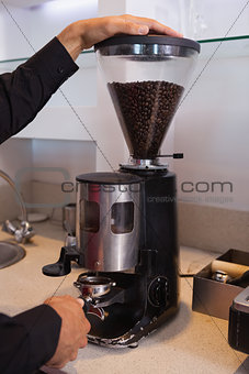 Barista grinding coffee beans