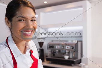 Pretty barista smiling at camera
