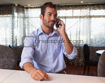 Happy businessman on the phone after work