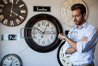 Handsome businessman checking the time