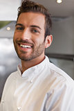 Cheerful handsome young chef looking at camera