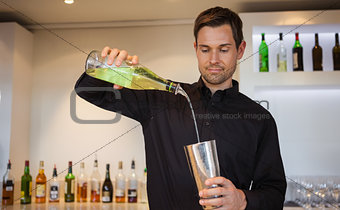 Happy bartender making a cocktail
