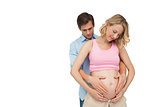 Expectant happy parents holding mothers baby bump