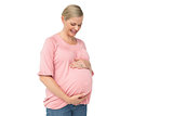 Pregnant woman looking down at her bump