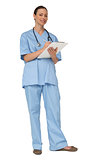 Smiling nurse in scrubs writing on clipboard
