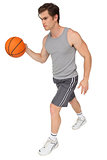 Fit man playing basketball