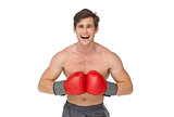 Fit man wearing red boxing gloves and shouting