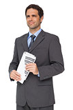 Handsome businessman holding a newspaper