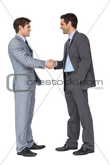 Happy business partners shaking hands