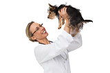 Vet lifting up yorkshire terrier and smiling
