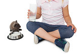 Cute girl and grey kitten both having milk