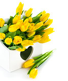 spring yellow tulips in wooden basket