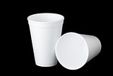 two styrofoam cups on black