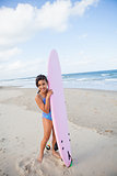 Happy young girl with surfboard