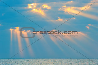 rays of the sun breaking through the clouds over the sea