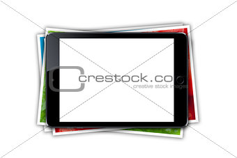 Tablet with blank screen and stack of printed pictures collage