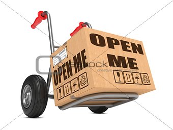 Open Me - Cardboard Box on Hand Truck.