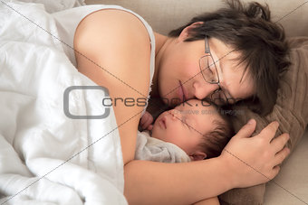 Mother and newborn baby asleep