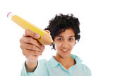 hispanic business woman holding huge yellow pencil