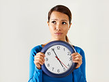 asian girl holding big blue clock with stress