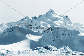 Mountains in snow in cloudy weather