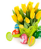 easter eggs with yellow tulips in watering can