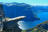 Trolltunga summer view (Norway) and man on rocks edge.