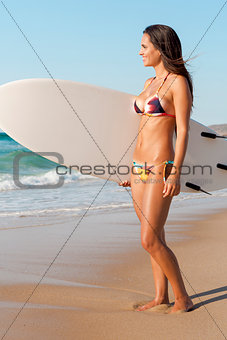 Surfer girl with her surfboard