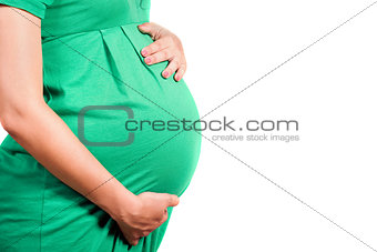 Belly of a pregnant girl in green dress
