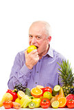 Senior man eating a green apple