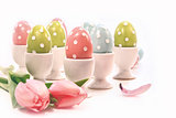 Colorful easter eggs in white cups